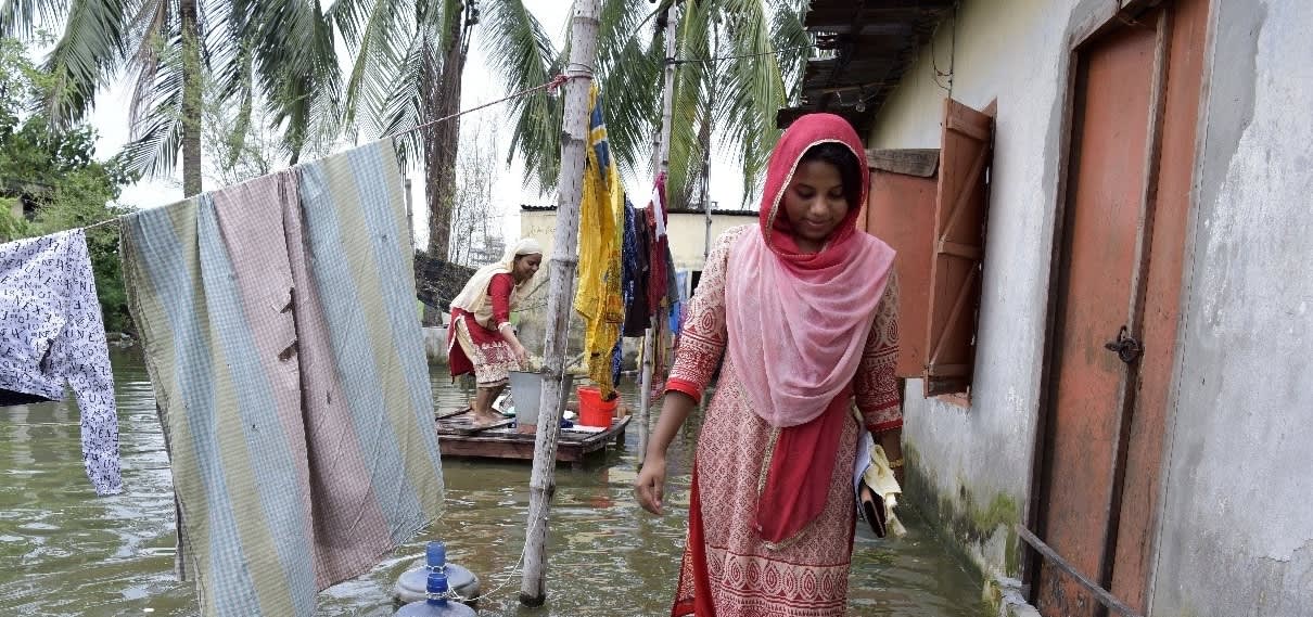 Woman walking on flooded area