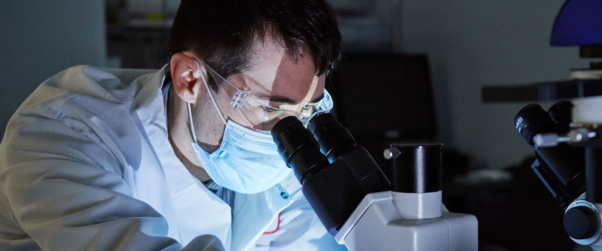 Man looking through microscope