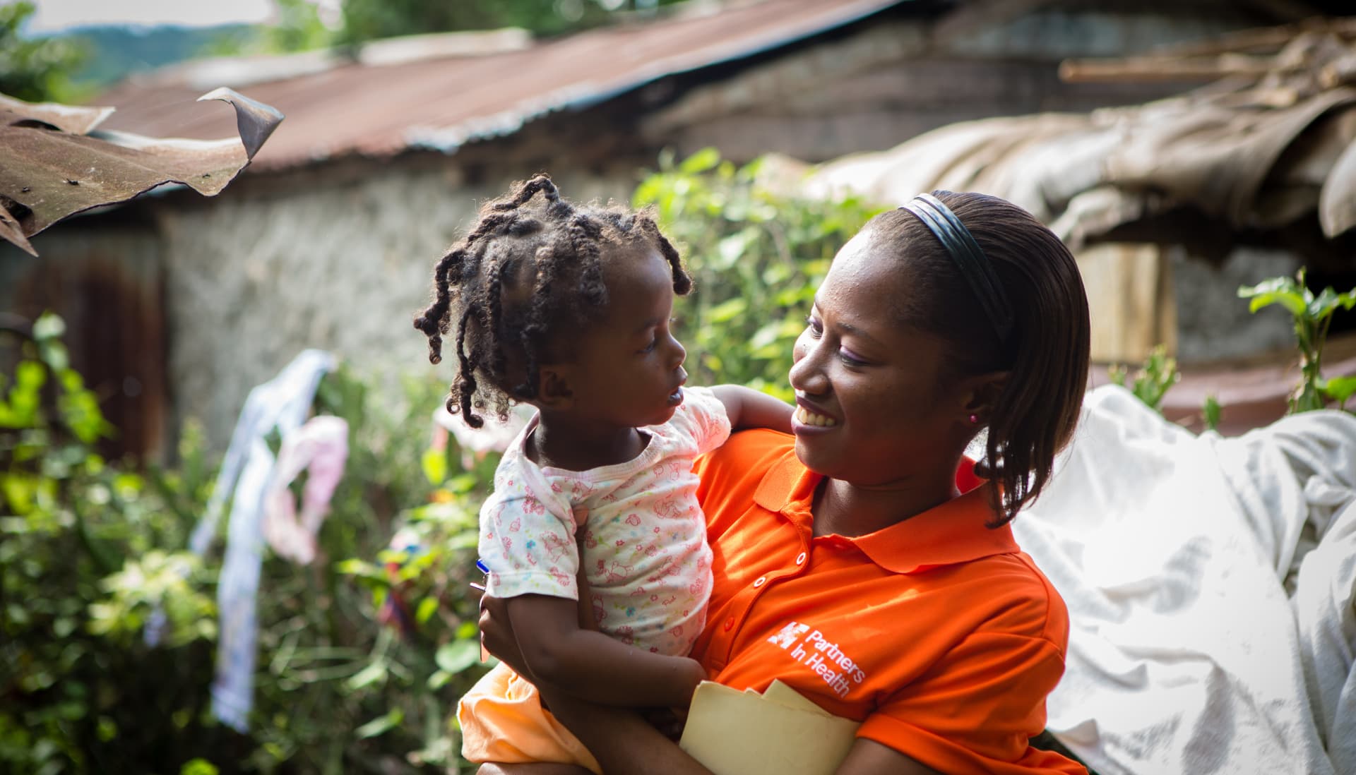 A woman is holding a child.