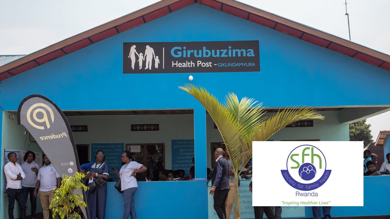 People gathered outside a blue health post building