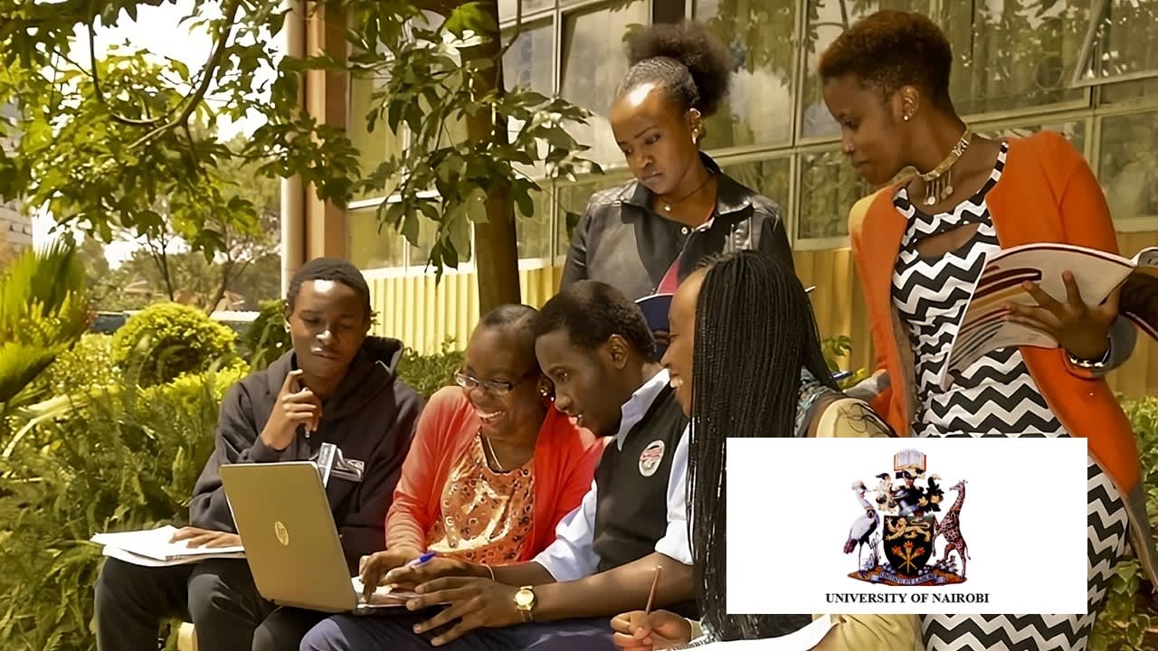 A group of people sitting outside in a garden, working together on a project