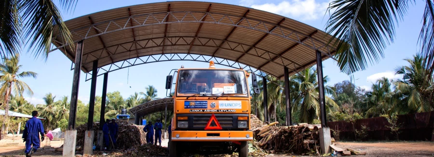 A medical waste collection truck at a covered facility in Bangladesh, representing climate-resilient healthcare waste management infrastructure.