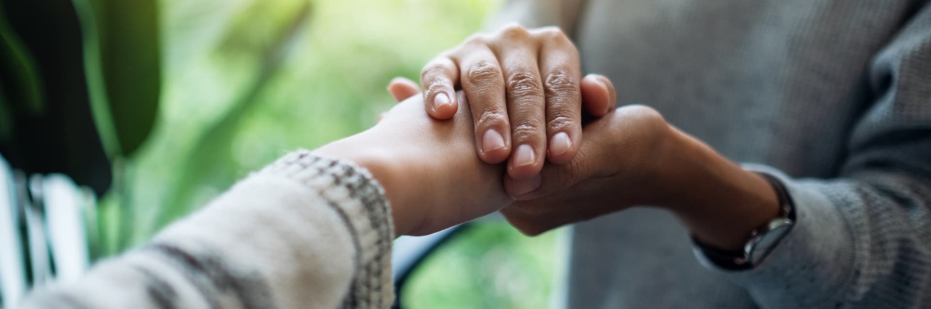 Person comforting someone's hands