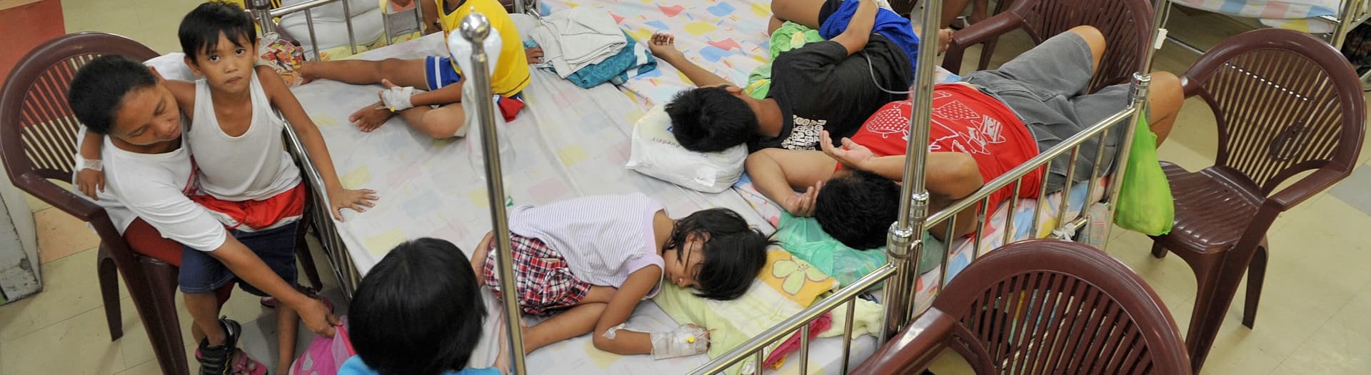 Young victims of an outbreak of dengue fever crowd the children's ward of the government-run Quirino Memorial Hospital in Manila