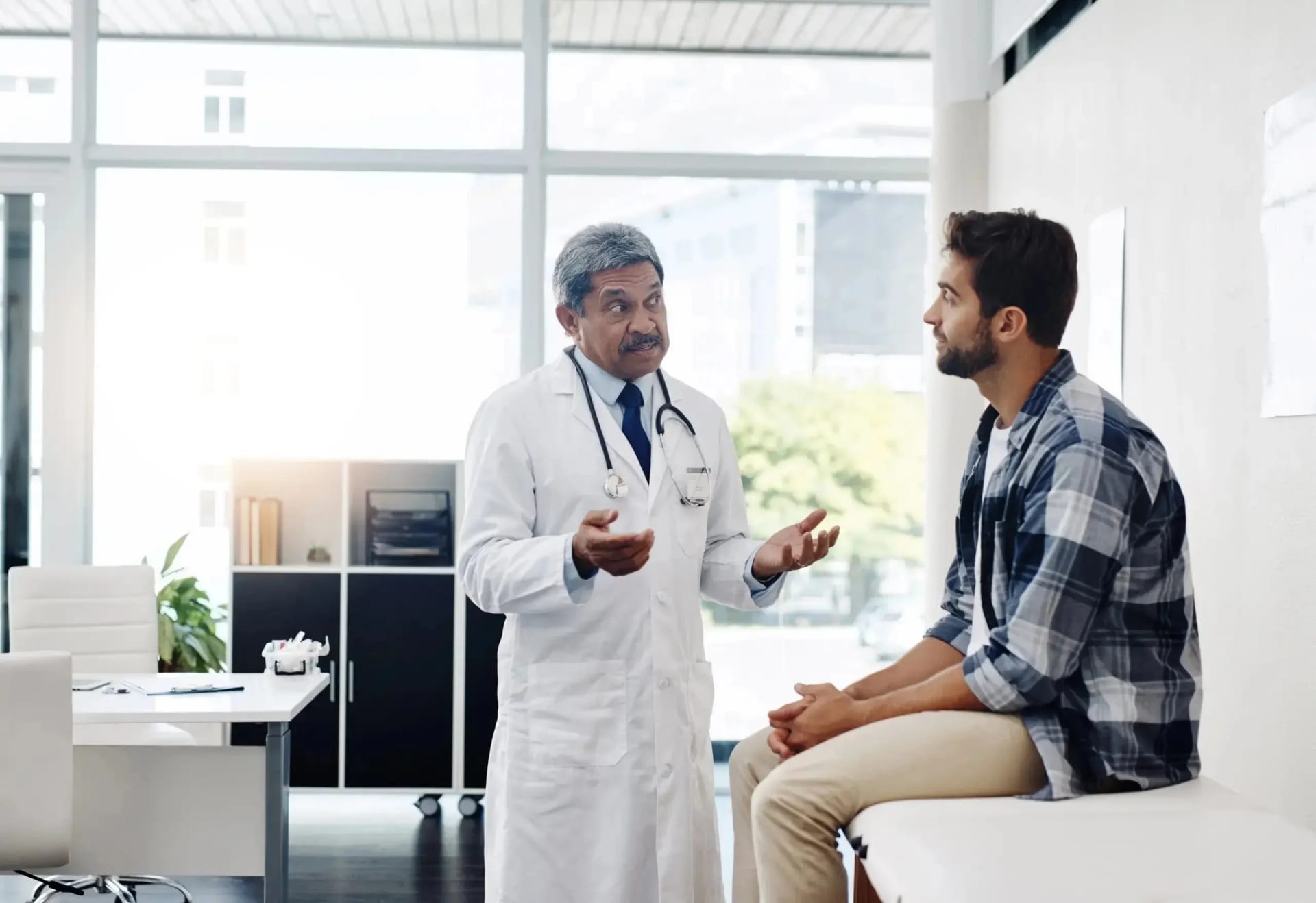 Doctor consulting with a patient in a bright medical office.