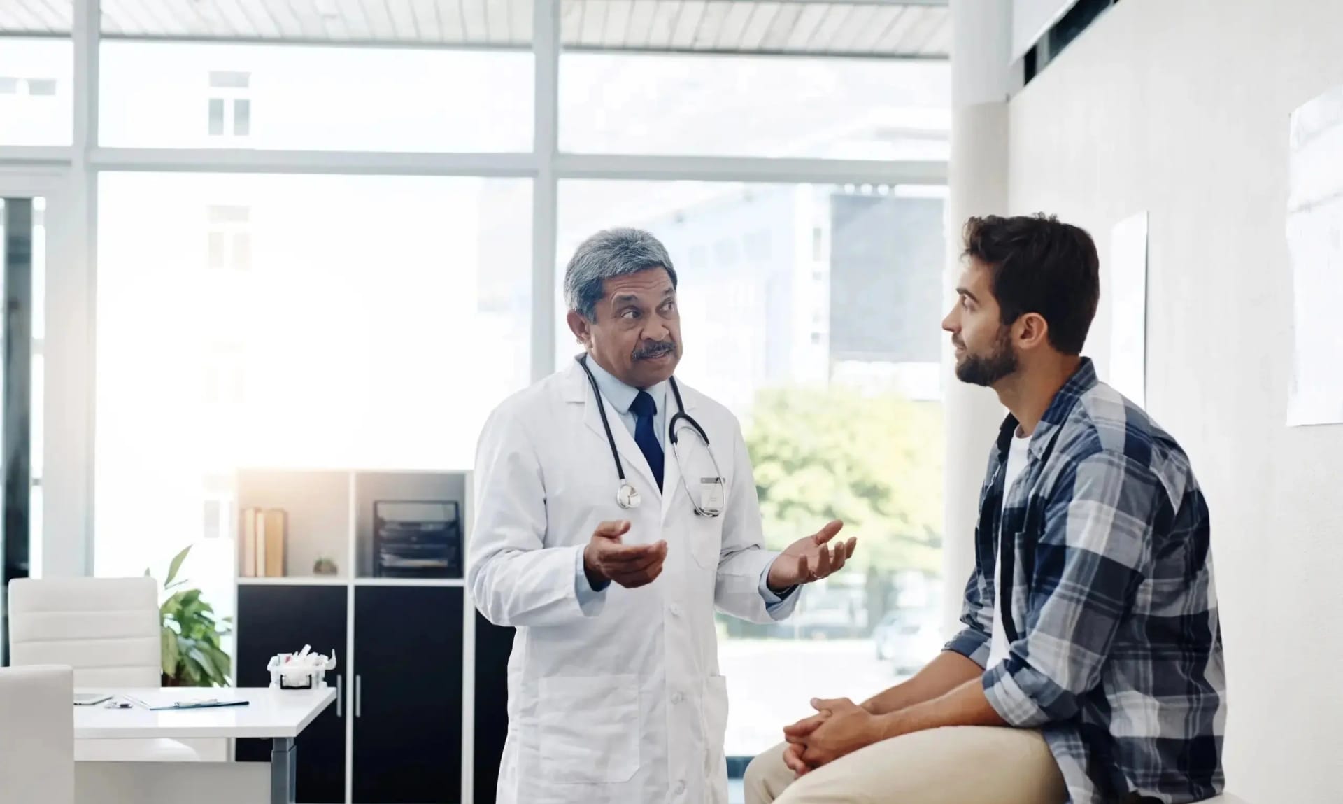 Doctor consulting with a patient in a bright medical office.