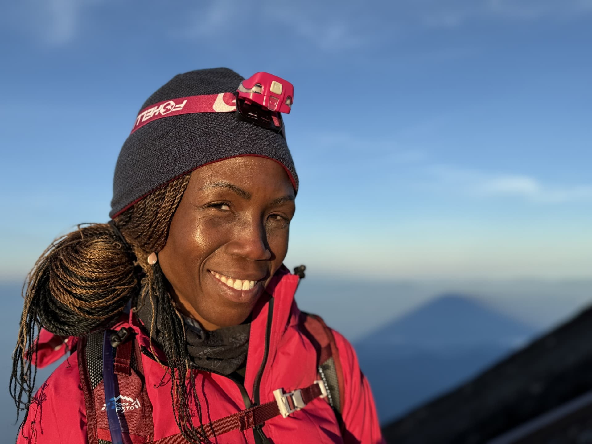 Woman posing for picture while hiking
