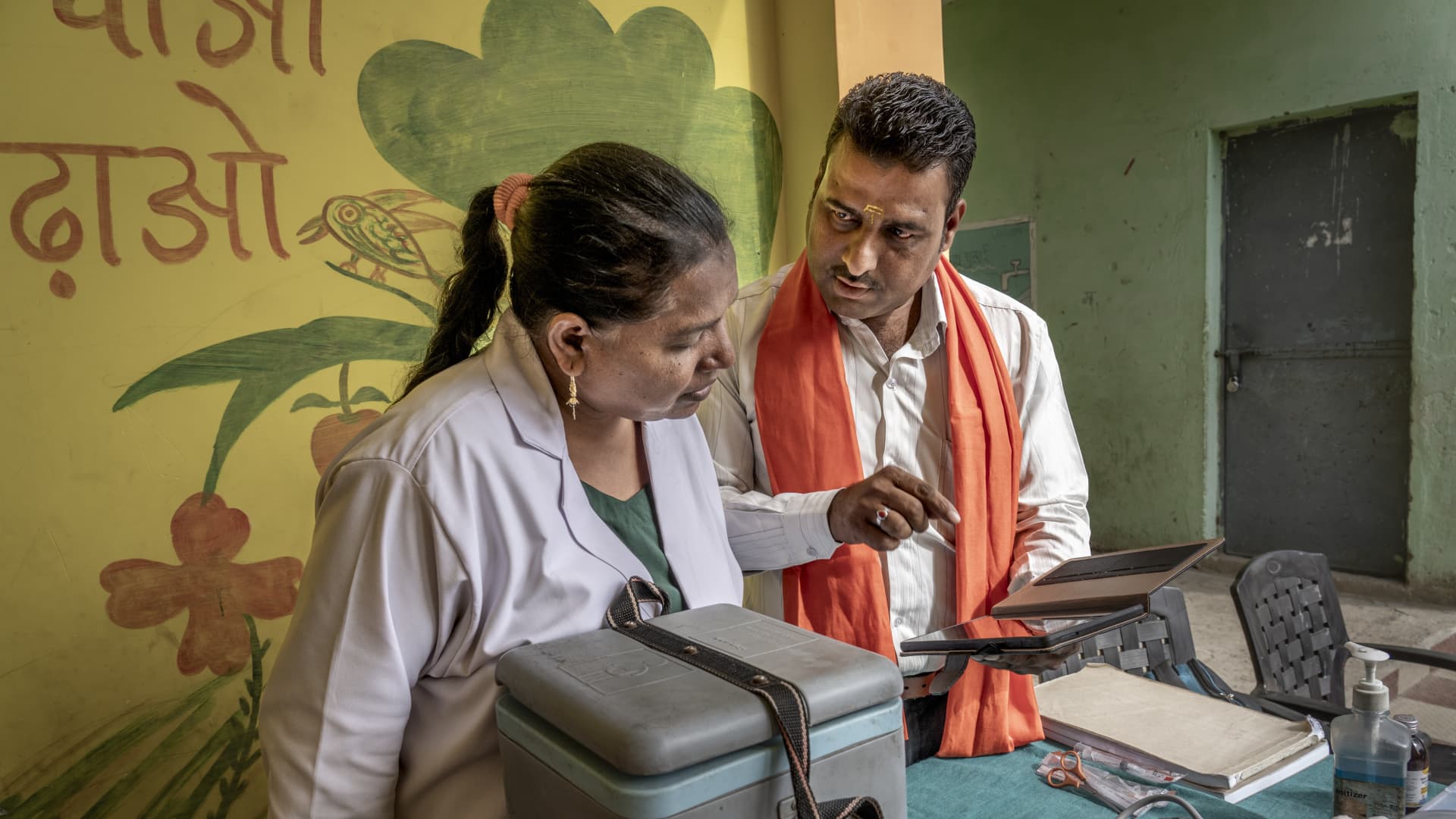 Two doctors looking at a tablet