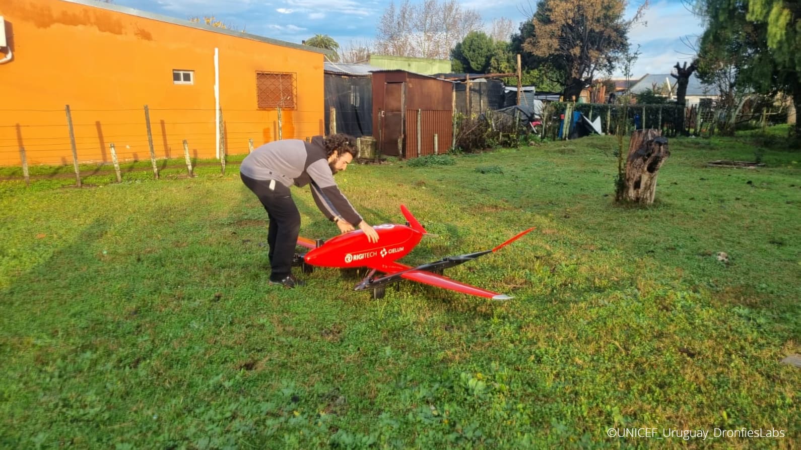 A man prepares to retrieve a delivery of medical supplies from a drone.