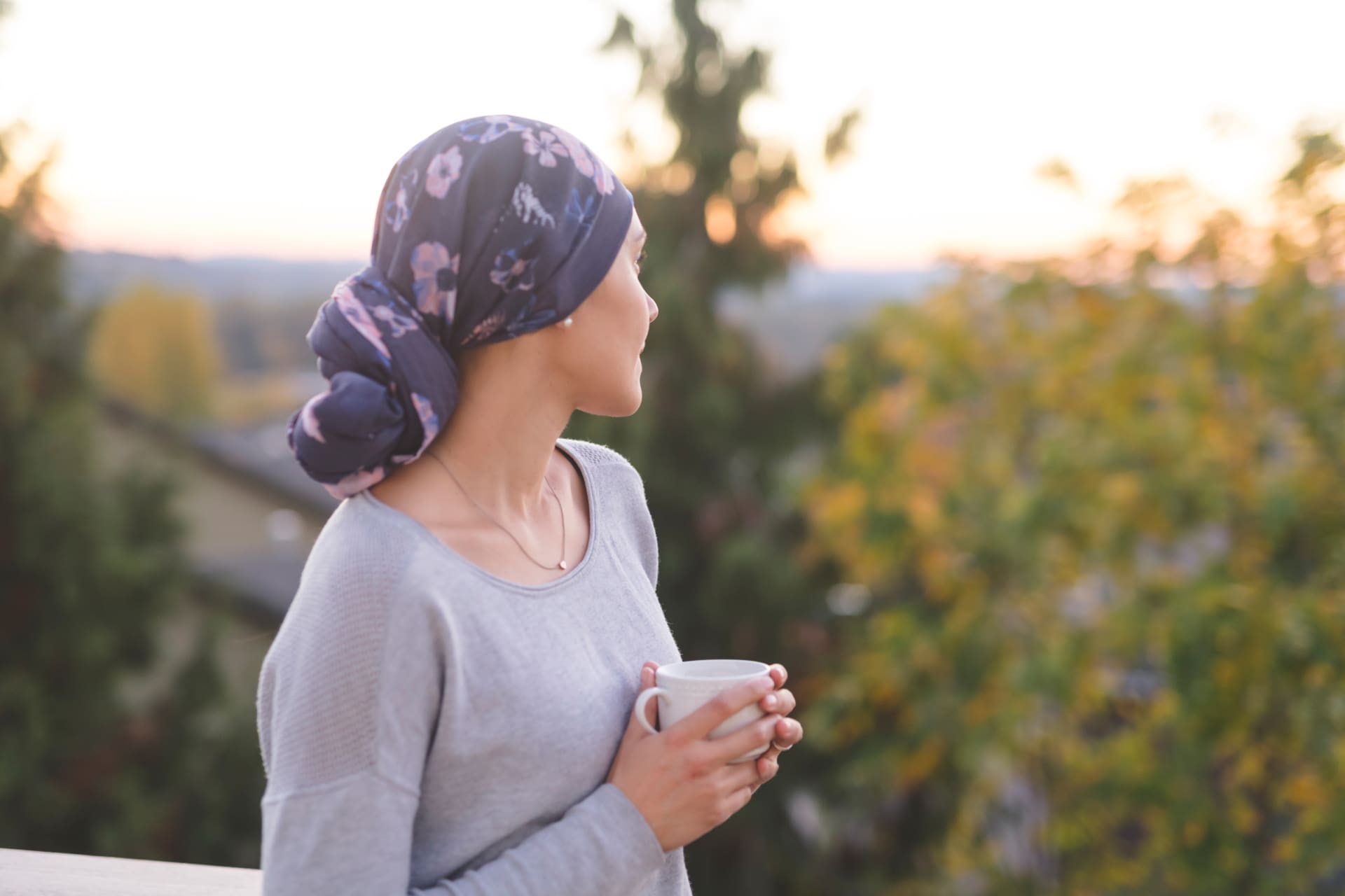 Woman staring at the sky with a mug