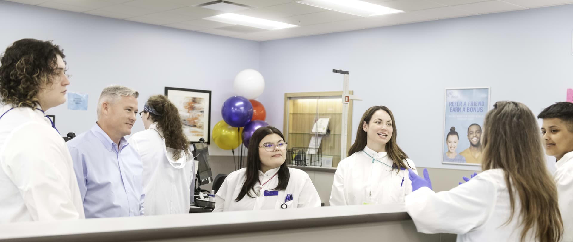 Seven people talking in biolife facility