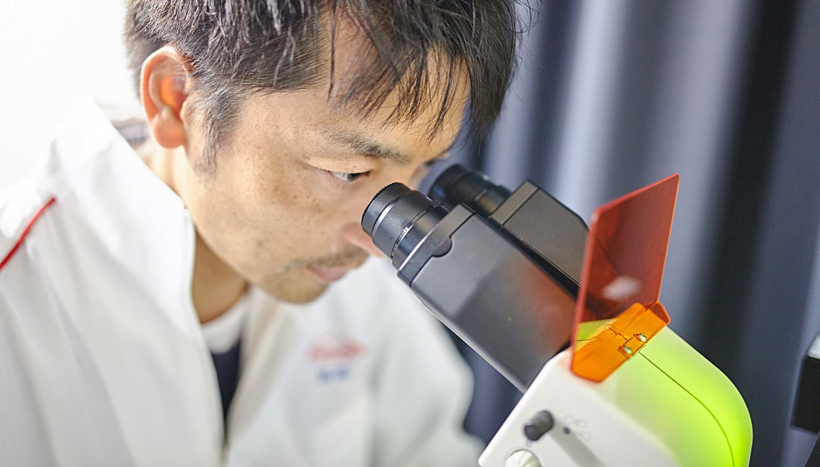 Man looking into microscope