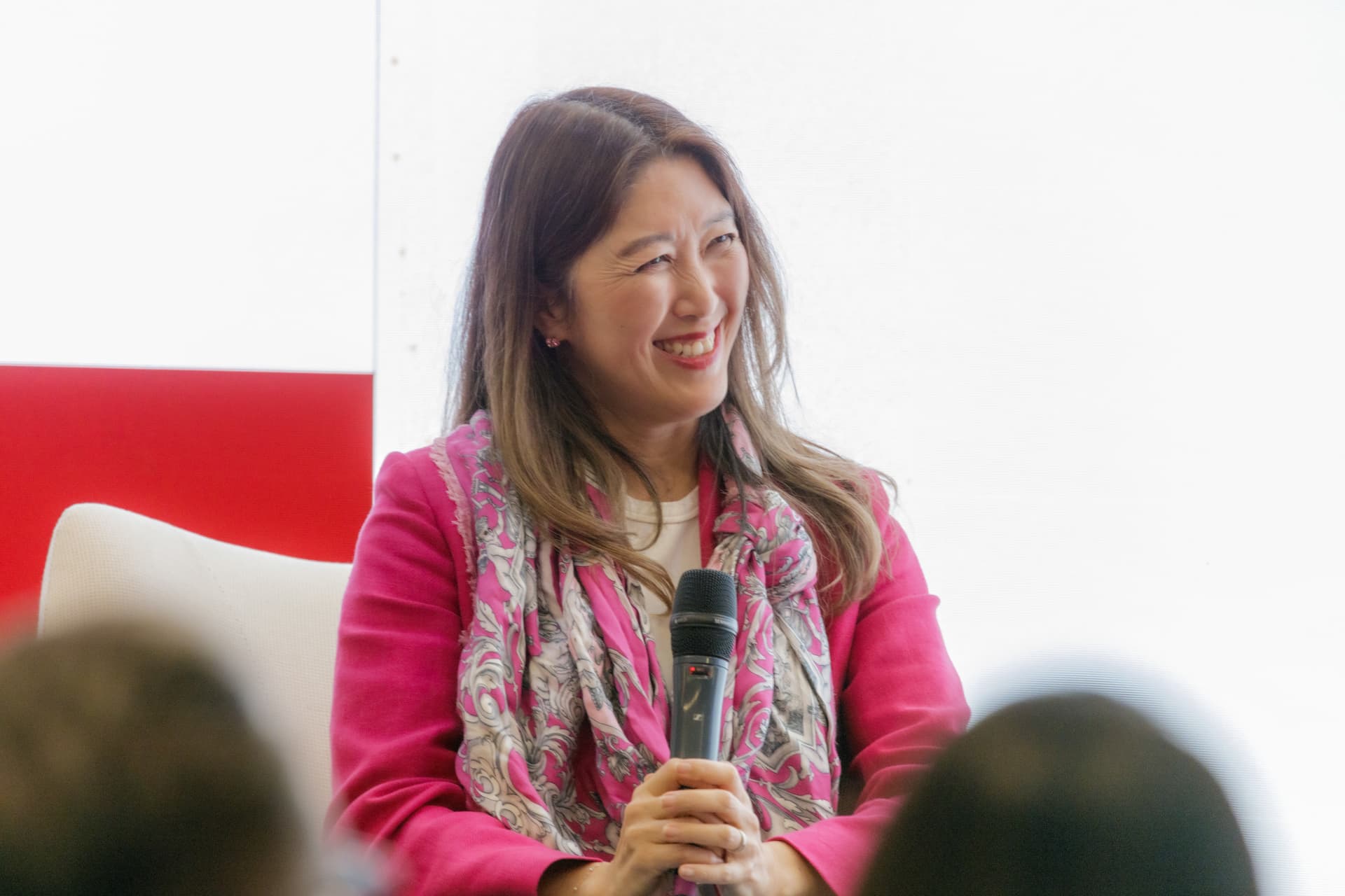Julie Kim holding a microphone.