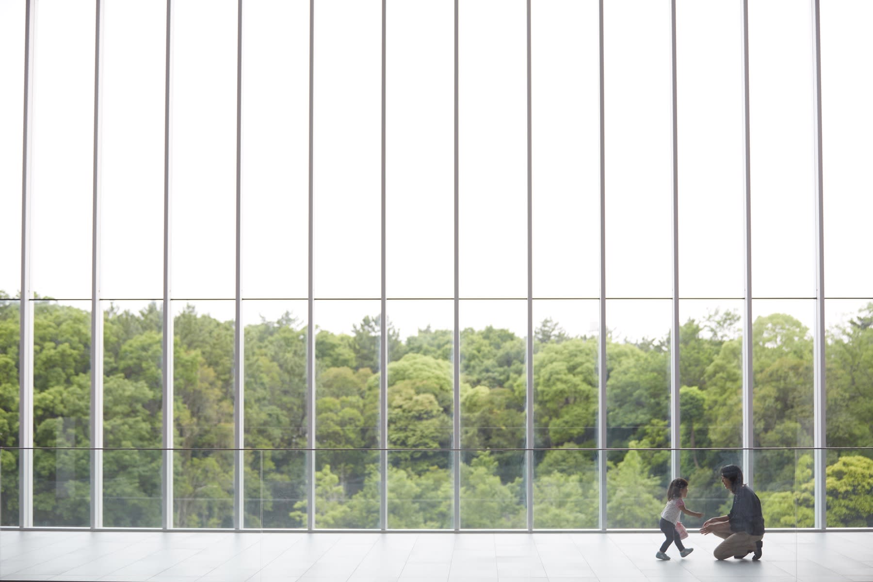 A woman and a child walking in a large room