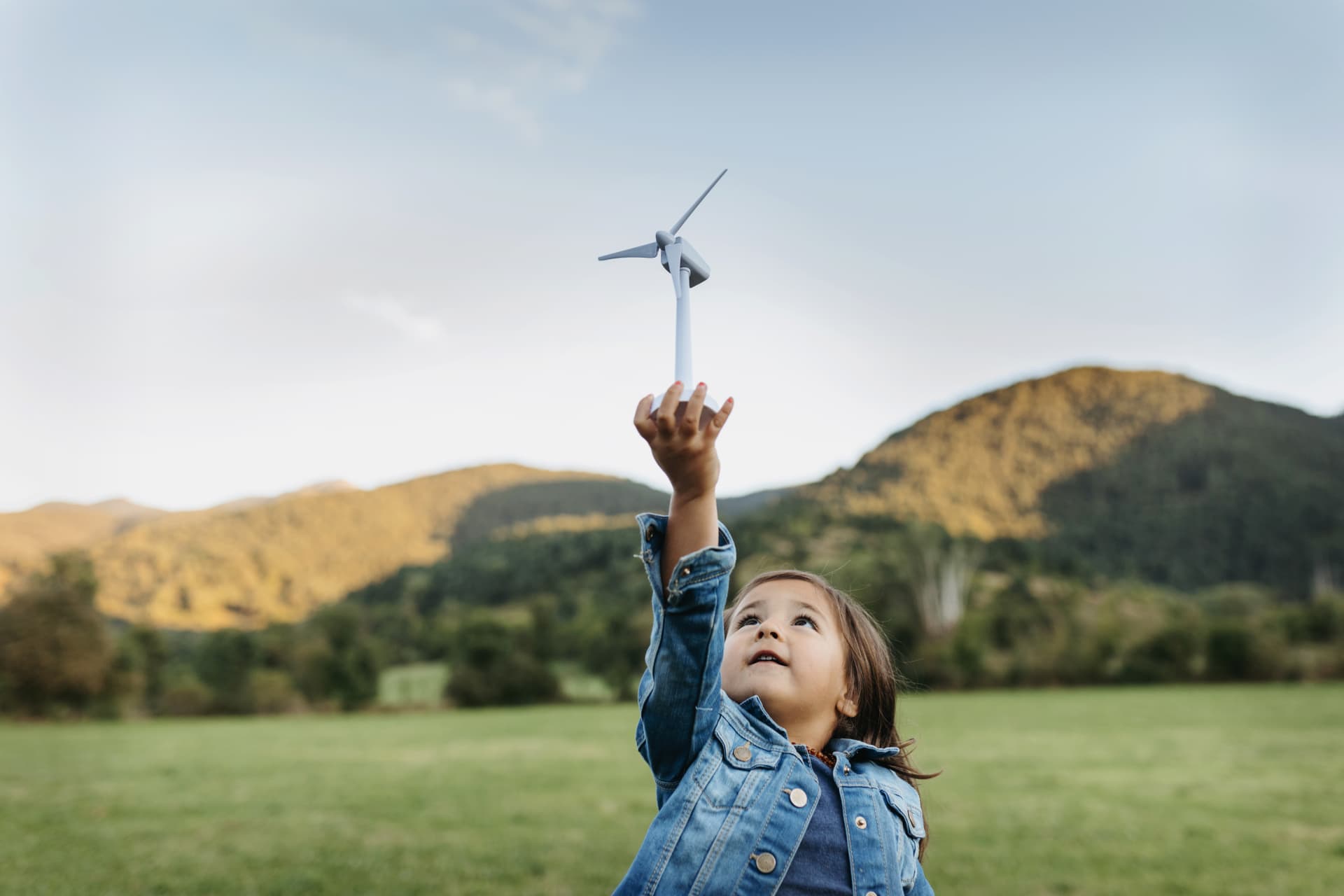A child holding a toy windmill