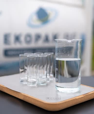 A glass beaker and several small glasses