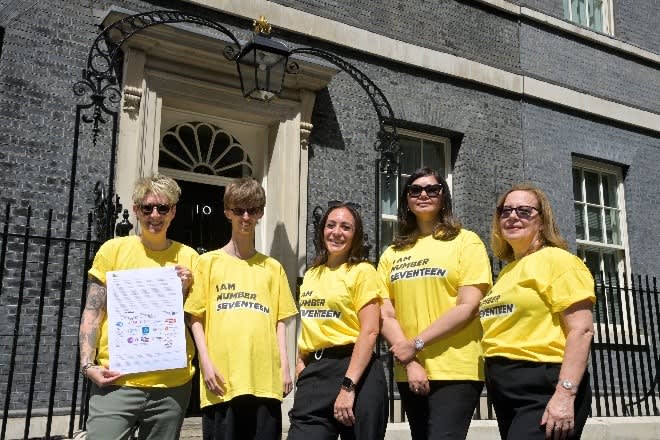 A group of people wearing yellow shirts