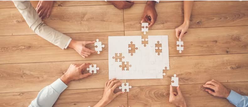 Hands completing a puzzle