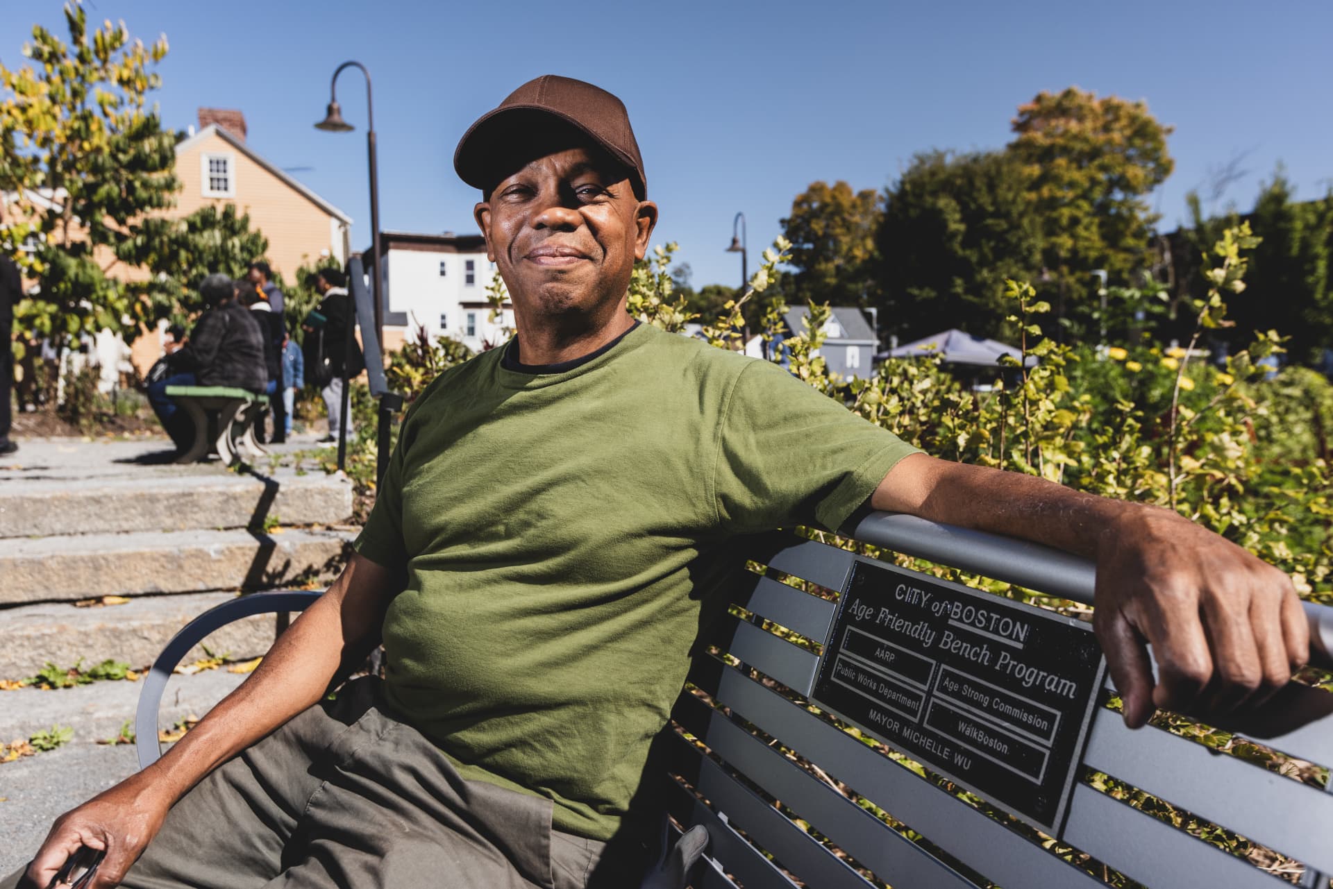 Apolo Cátala sits on a bench at the Urban Farming Institute’s farm stand.