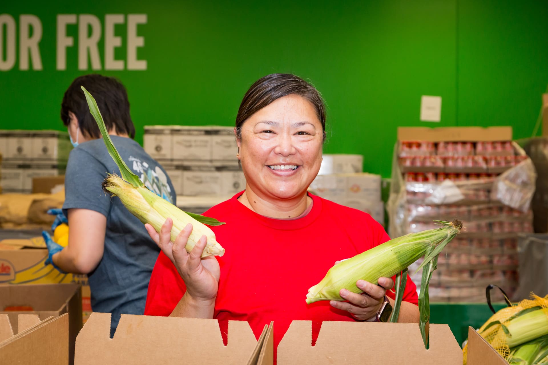 Smiling woman shows vegetables