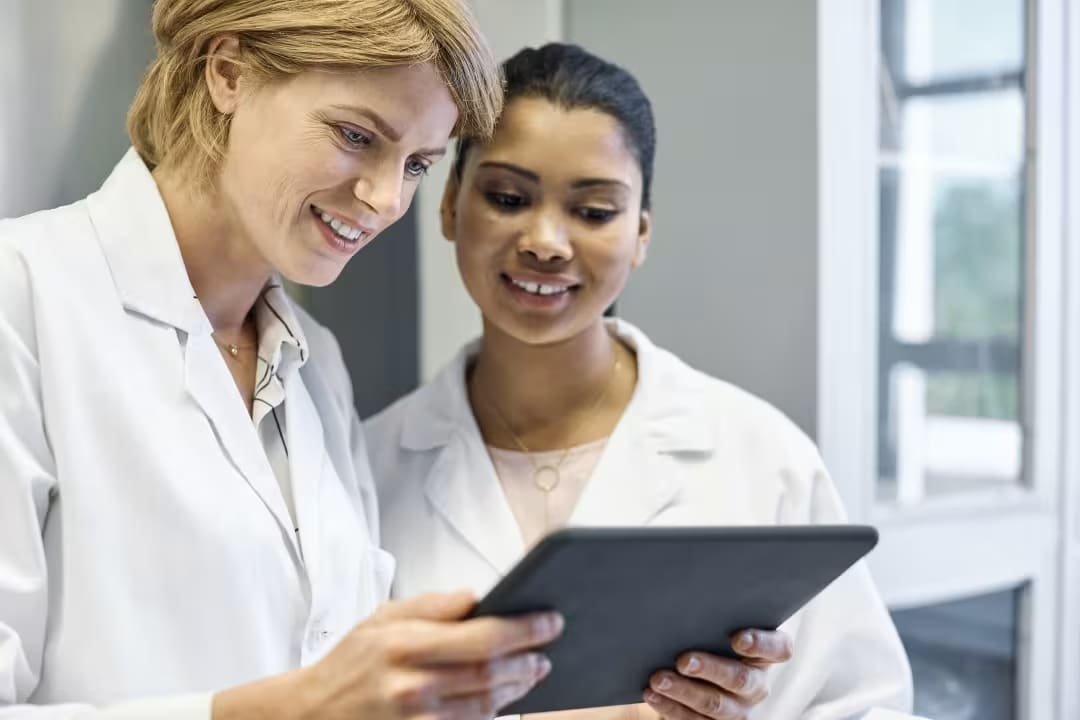 two healthcare professionals looking at tablet