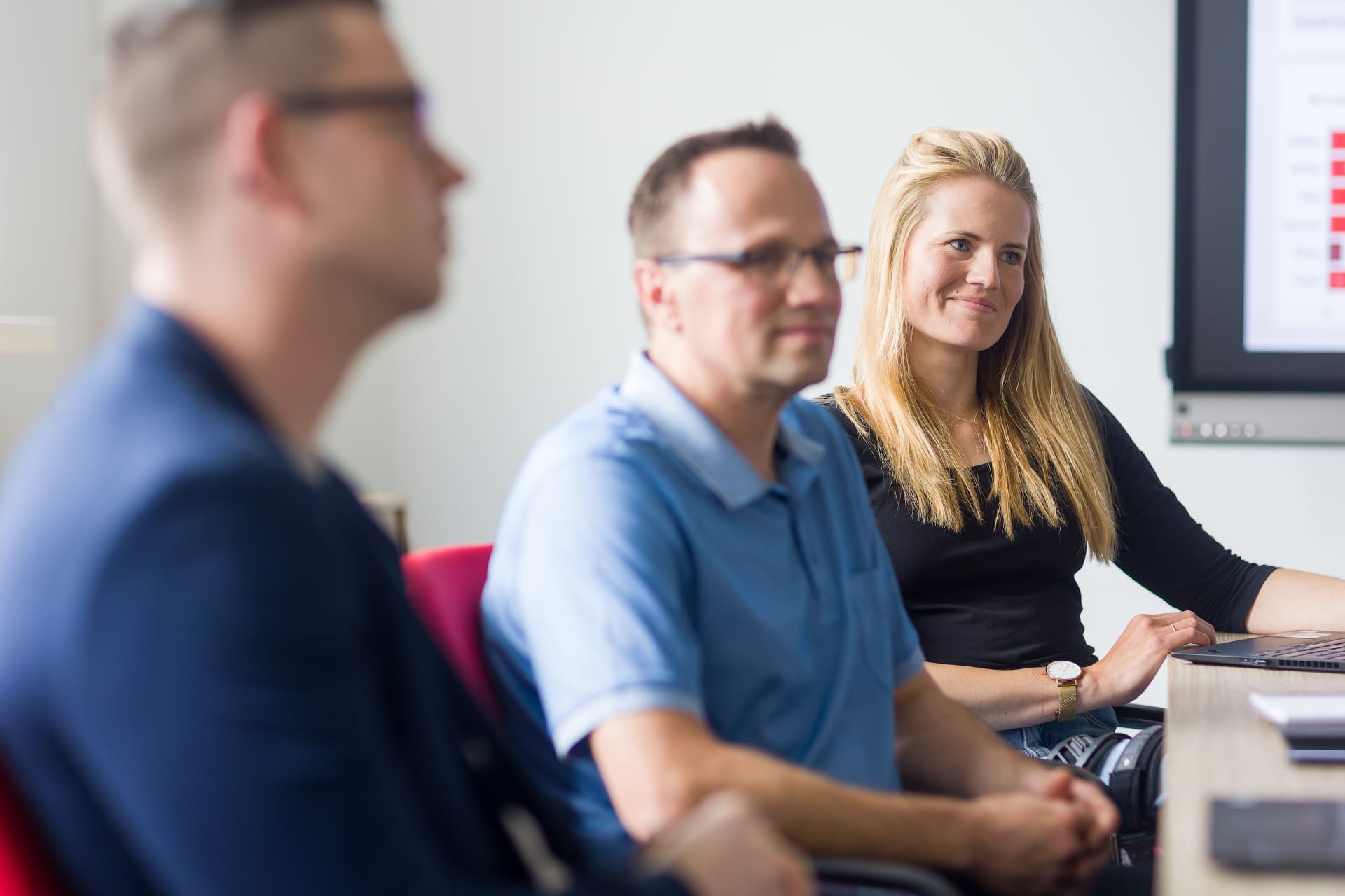 three colleagues in meeting room
