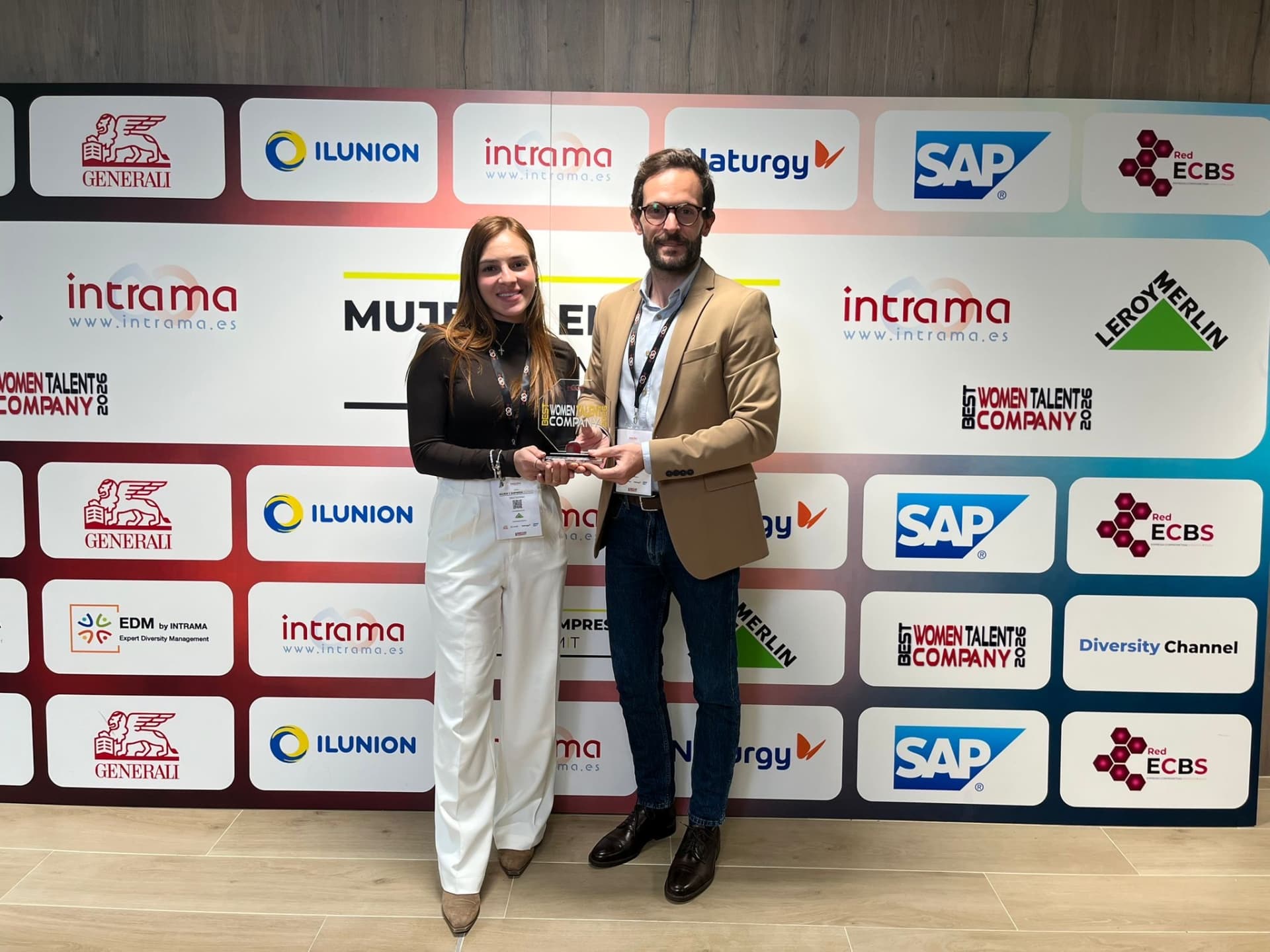 A lady receiving an award from a man