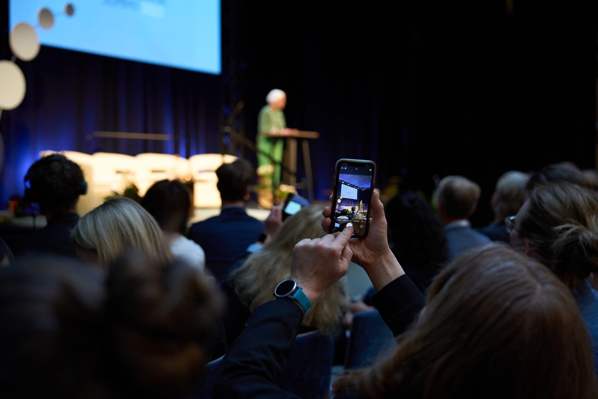 A group of people taking a picture of a person