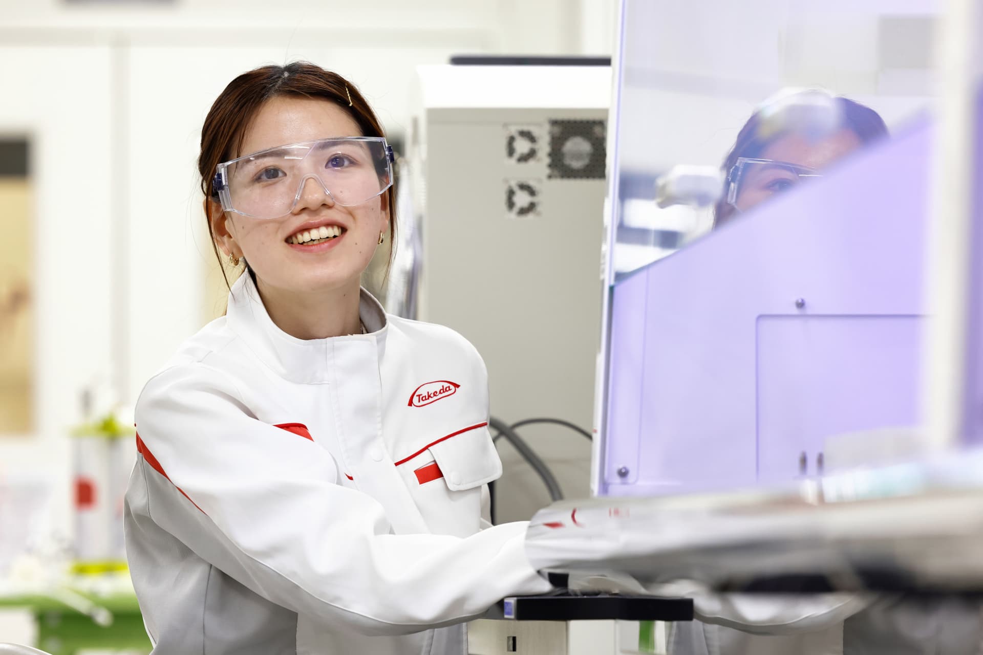 Woman with lab Takeda coat