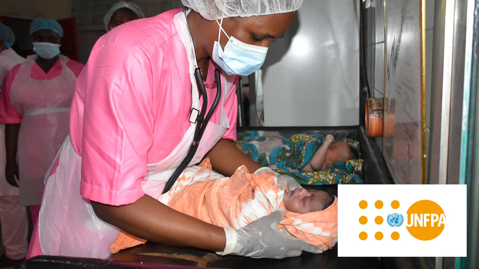 Health worker with two newborns