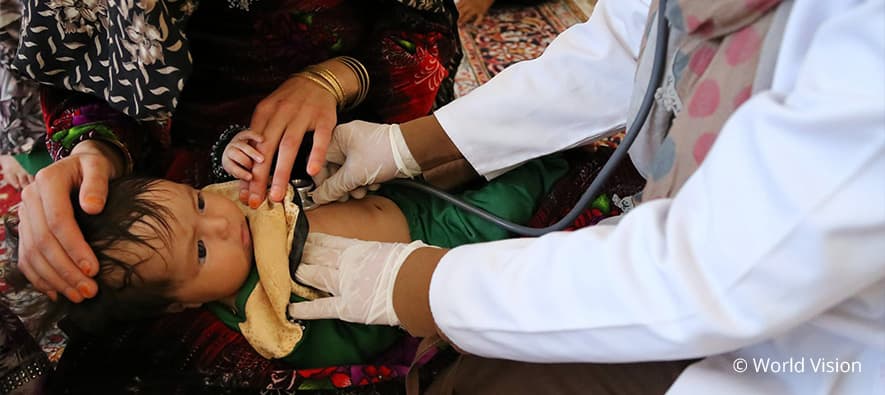 Physician listening to child's heartbeat with a stethoscope.