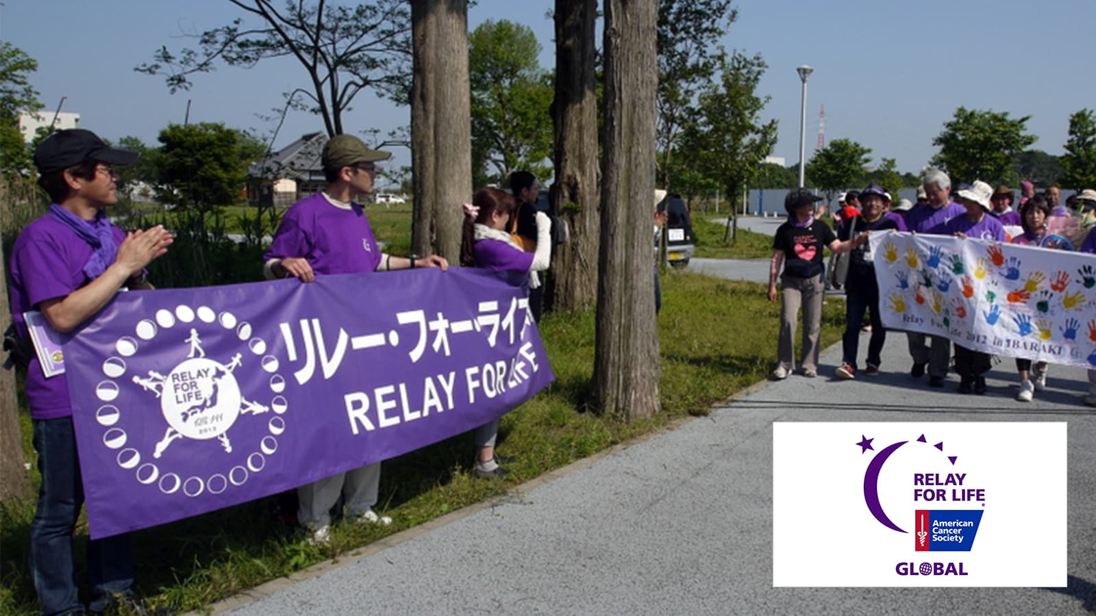 Two groups of people with relay for life banners