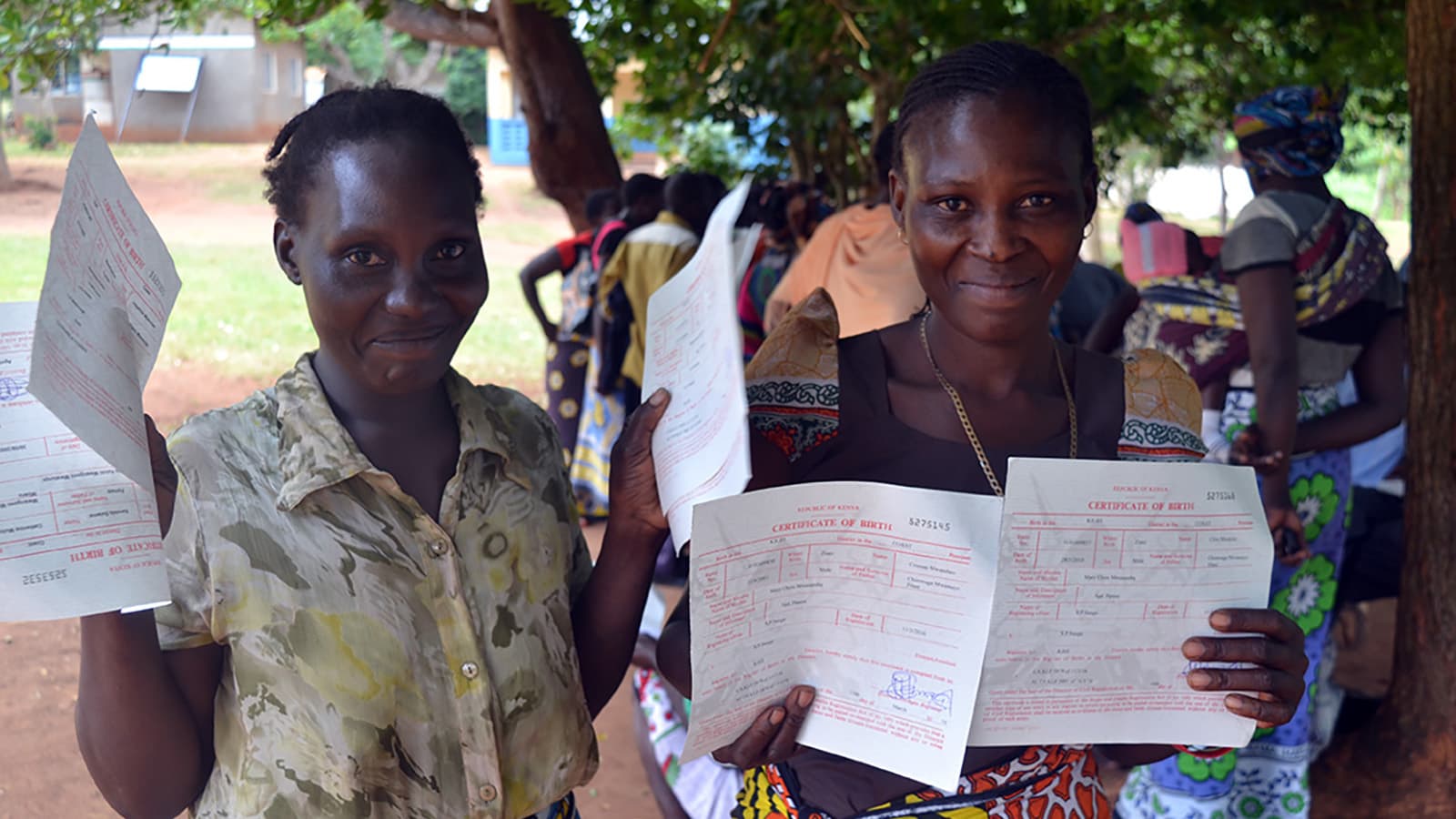 Two women with digitalized certificate of birth