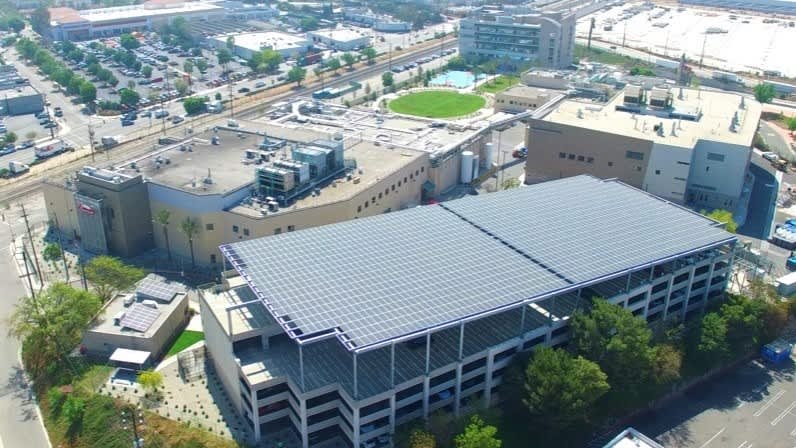 aerial picture of building with solar panels on the rooftop