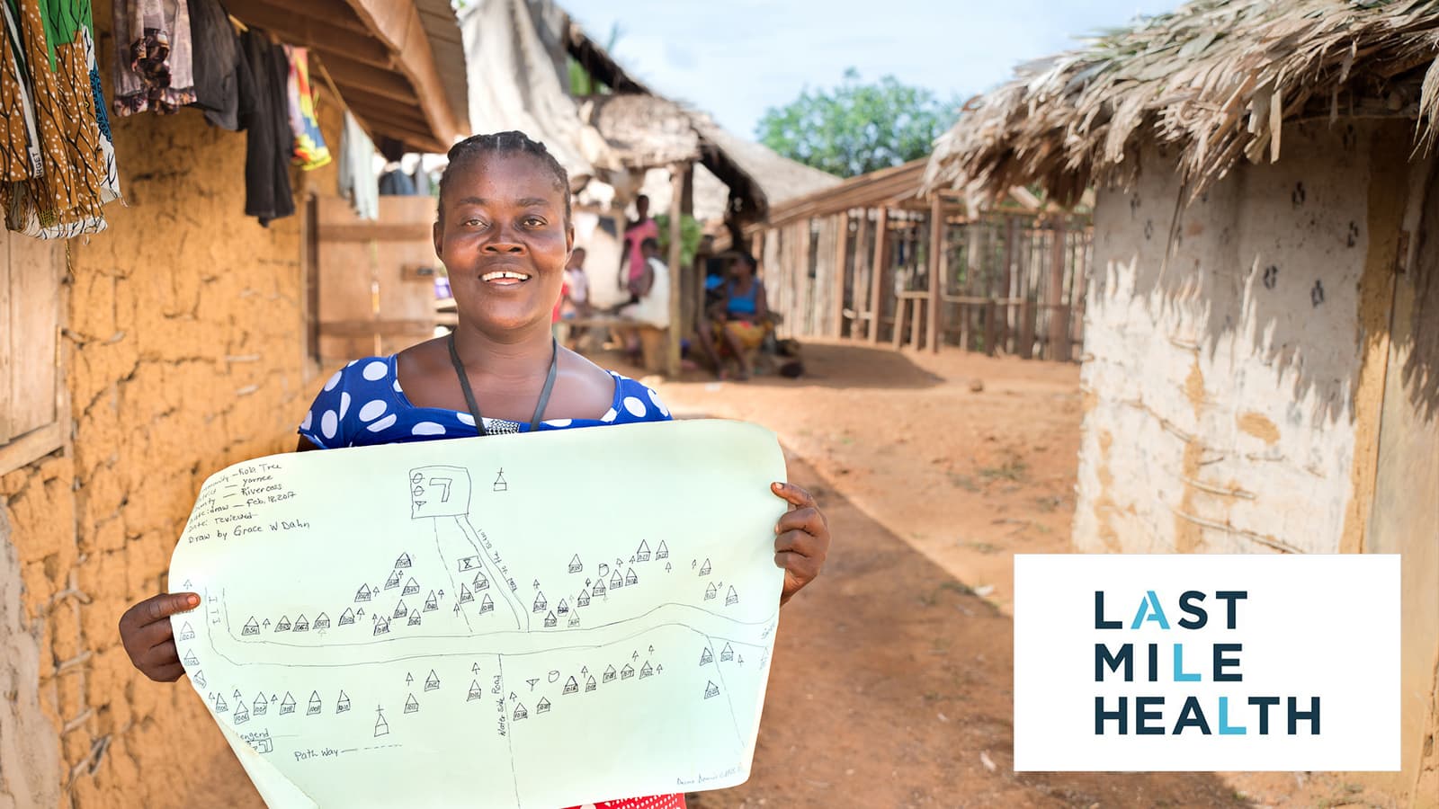 A woman is presenting a handdrawn map of a village