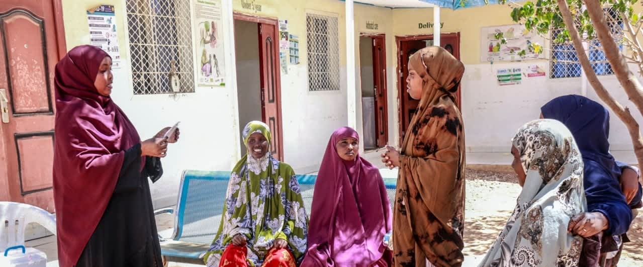 Group of six women discussing