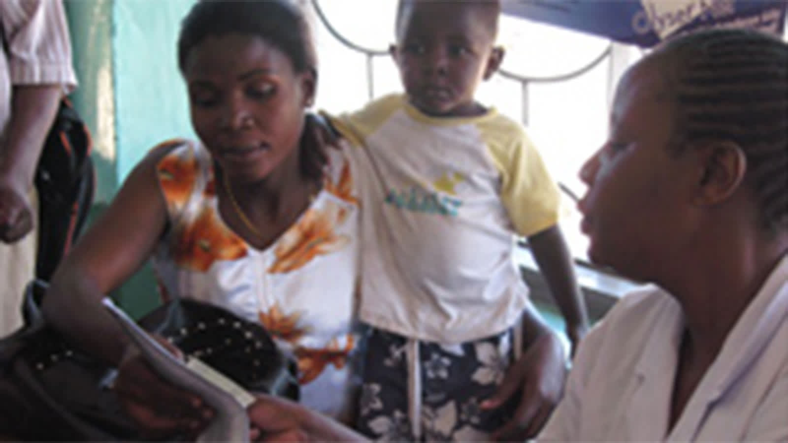 Child with mom and physician