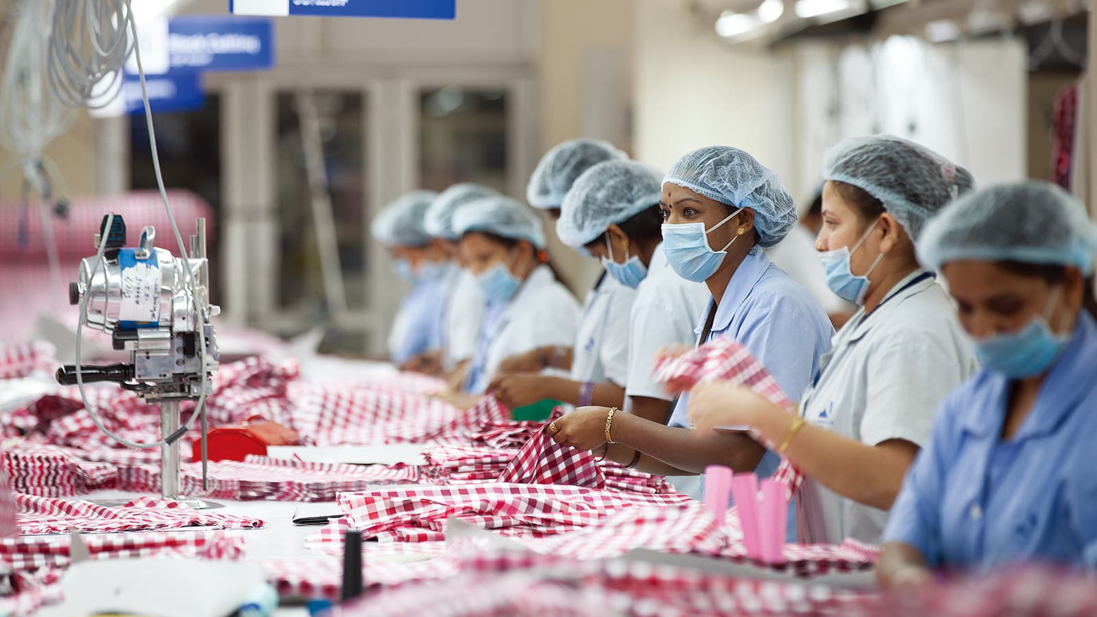Eight factory workers at sewing line