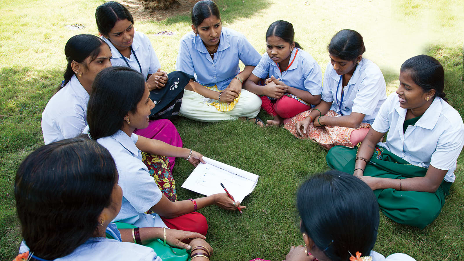 Group of nine women sitting in circle