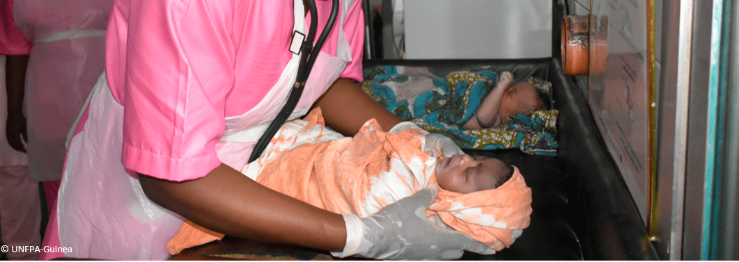 Health worker with two newborns