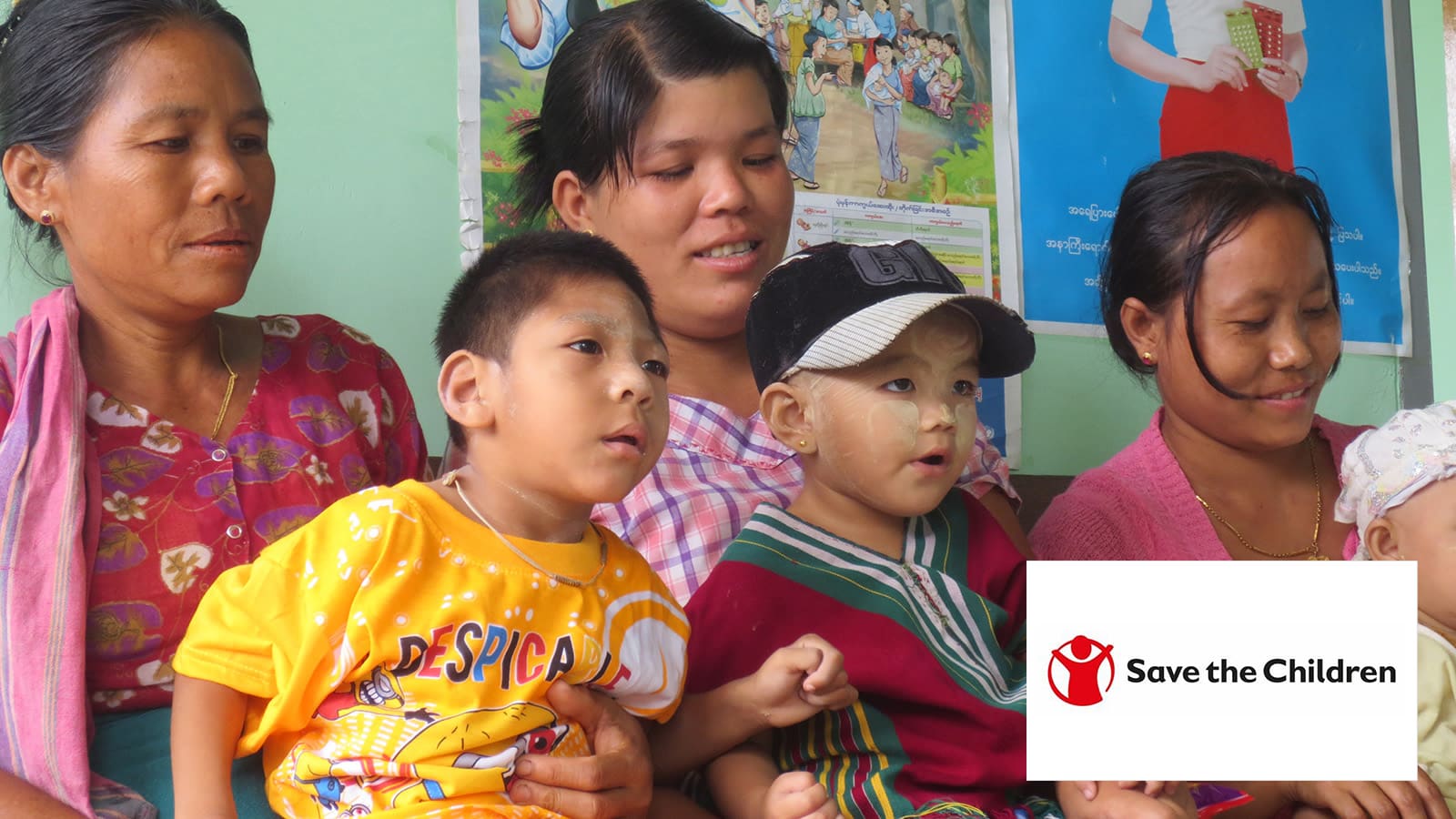 Three women with each of them carrying a child on their legs