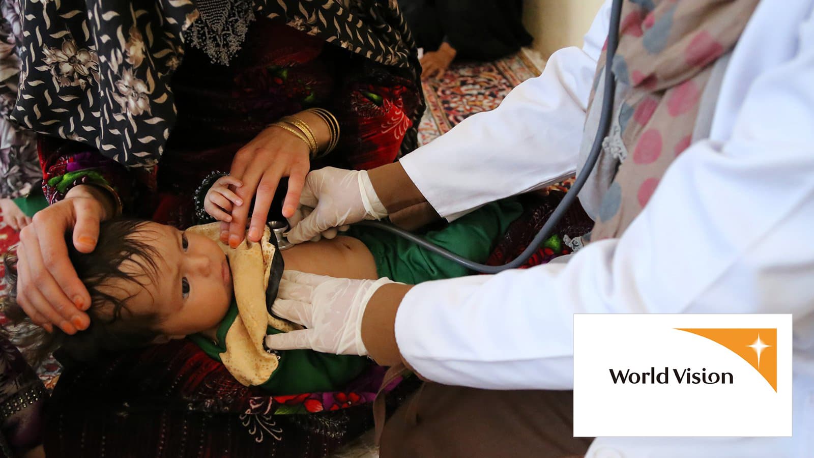 Physician listening to child's heartbeat with a stethoscope