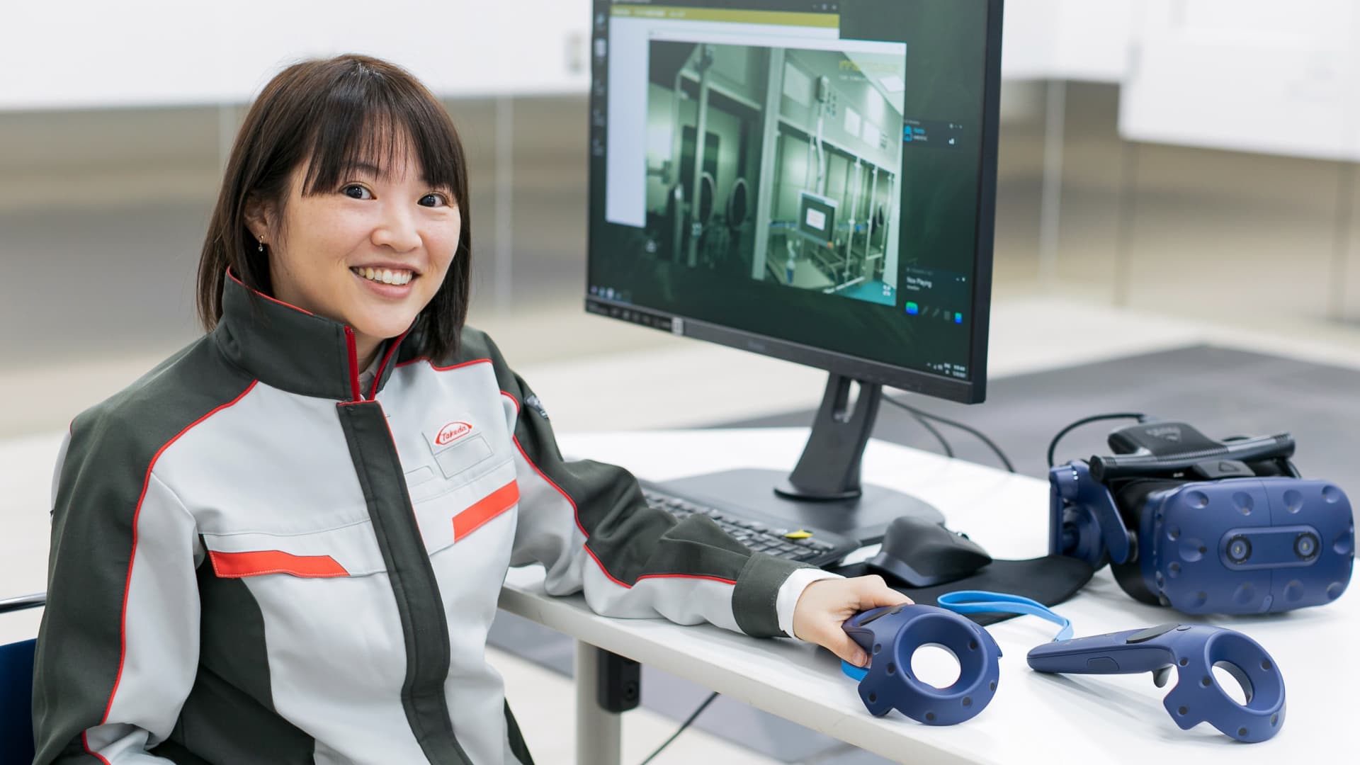 Takeda employee next to computer and virtual reality headset
