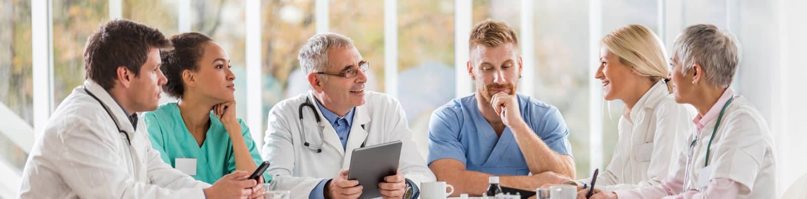 a group of physicians having a chat at a table