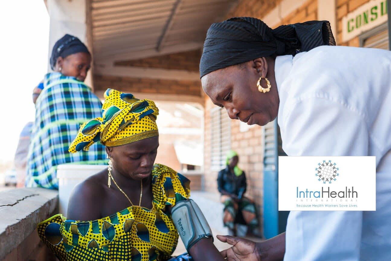 One woman is checking the blood pressure of another woman