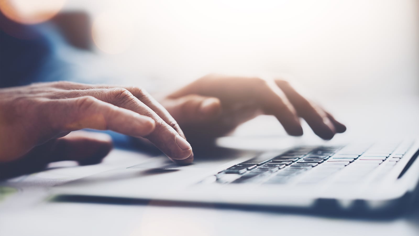 hands typing on keyboard