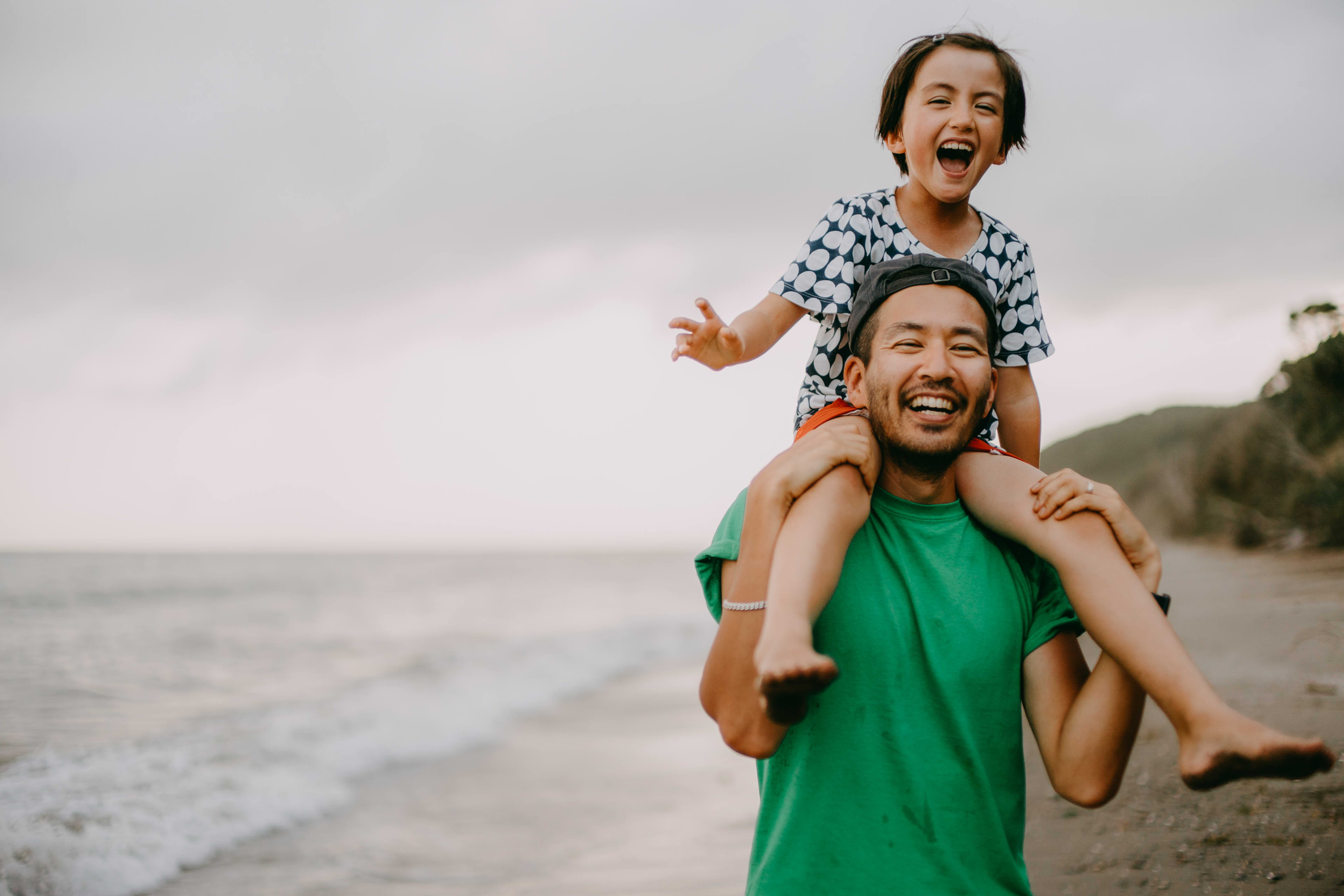 Dad carrying daughter on his shoulders