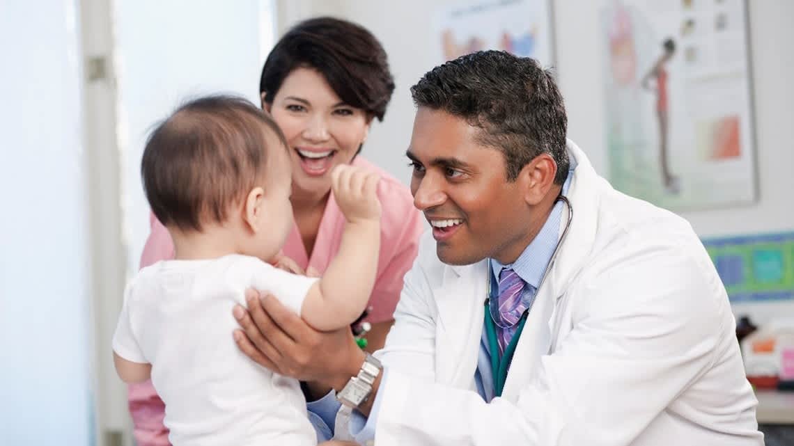 Doctor with baby and mom