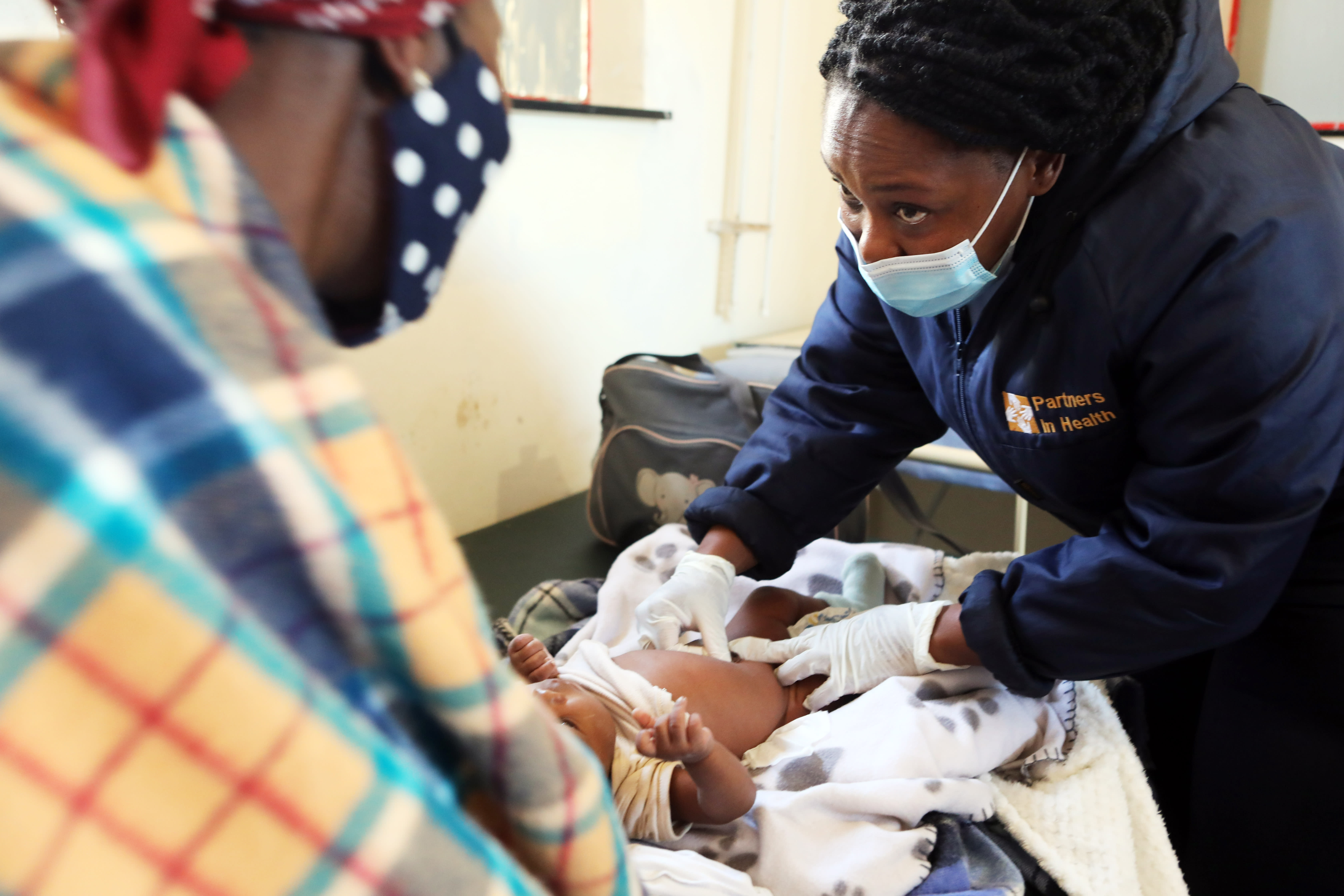 A nurse conducts a pediatric check-up for a 6-week-old at Nkau Health Center in Lesotho