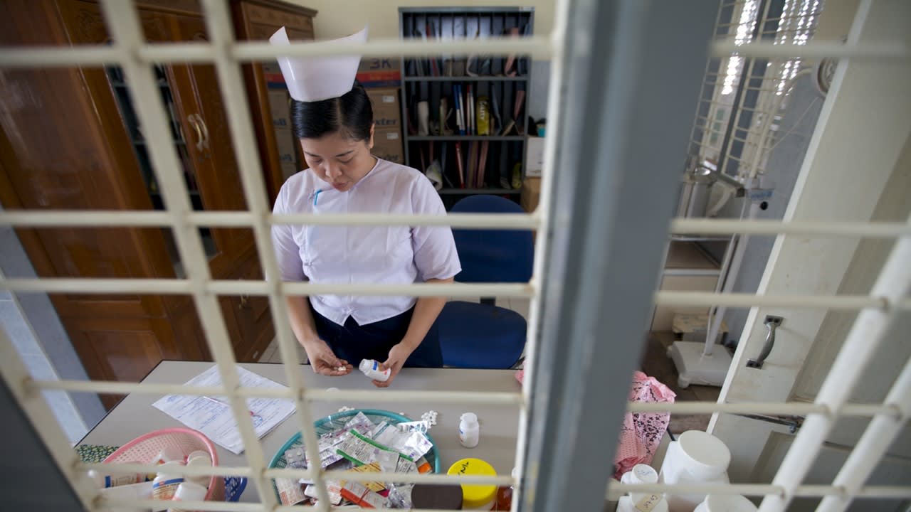 Nurse with various medicines on the table